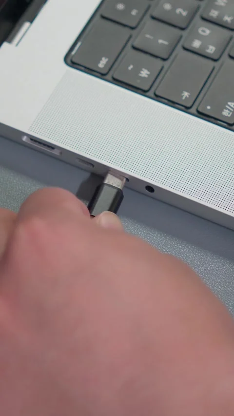 Plugging Type-C Cable Into Laptop Port Close Up Vertical 4K Video stock 338368537