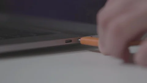 Plugging in a USB-C cable into a computer laptop Video stock 89800803