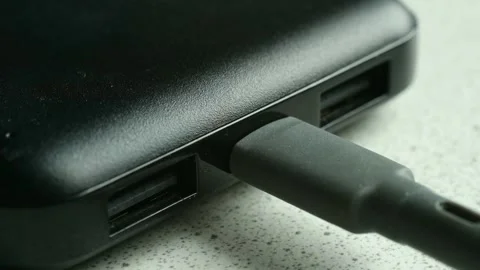 Plugging a usb c cable into a power bank Stock Footage 337828277