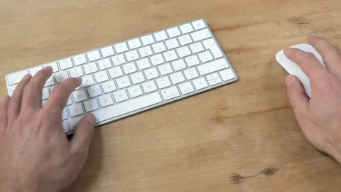 Plugging in usb-c hub into a laptop on wooden desk medium shot Stock Footage 120914615