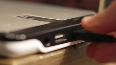 Plugging in USB Cable to Large Portable Battery for Charging Smart Phone on the Stock Footage 322557662