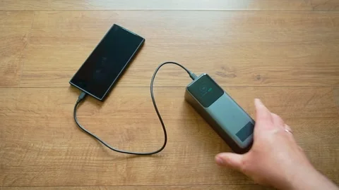 Plugging USB cable into power bank and smartphone close up portable charger Video stock 335816853