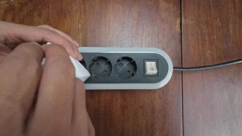 Plugging USB Wall Charger Into Power Strip on Wooden Table Stock Footage 311795897