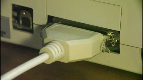 Plugging vintage parallel printer cable into printer Stock Footage 219096602