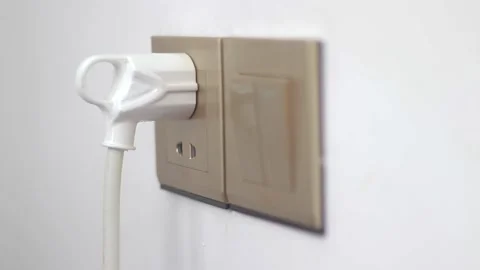 Plugging In To a Wall Socket Stock Footage 233858792