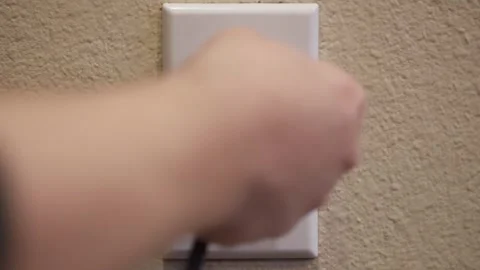Plugging in wall socket Stock Footage 322189365