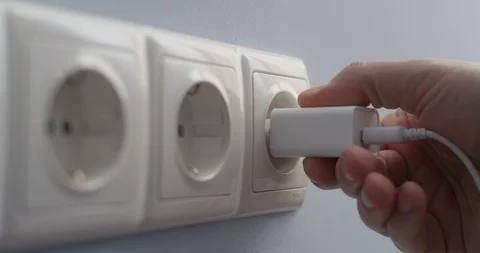 Plugging into A Wall Socket Hand Connecting Electric Plug USB Charger Stock Footage 102108642
