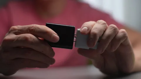 Plugging white adapter into charger, connecting electronic device for power Stock Footage 297627238