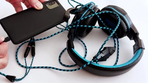 Plugging In: Wired Headphones Meet Smartphone in Simple Style Video stock 313184756