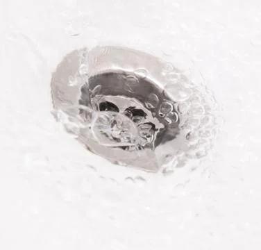 Plughole with water Foto stock