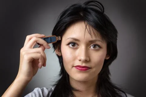 Pluging memory stick into head Stock Photos