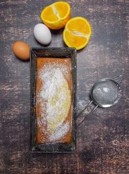 Plum cake flavored with oranges and cinnamon and icing sugar. Stock Photos