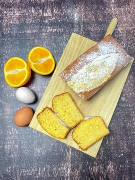 Plum cake flavored with oranges and cinnamon and icing sugar. Stock Photos