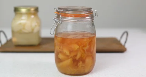 Plum compote at the front and peach compote on wooded tray at the back Stock Footage 113918026