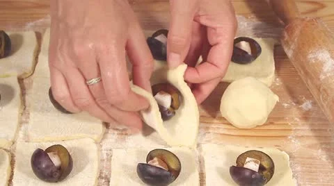 Plum dumplings being made: the plums being wrapped in dough Stock Footage 24673405