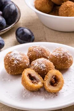 Plum dumplings on white plate Stock Photos