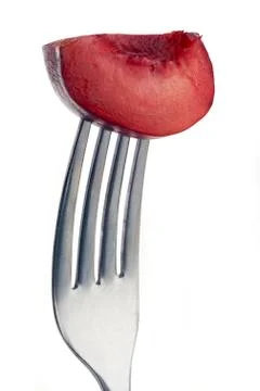 Plum on fork Stock Photos