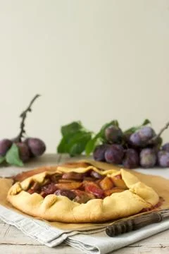 Plum galette with corn flour. Rustic style, selective focus. Stock Photos
