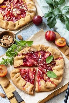 Plum Galette. Healthy homemade wholegrain fruit pie (galette) with plums and  Stock Photos