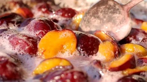 Plum jam is cooked in a large saucepan closeup. Shallow depth of field Stock Footage 160959726