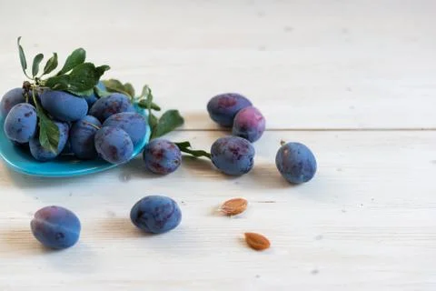 Plum in a plate on the table Stock Photos