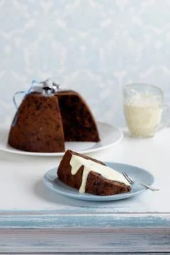 Plum pudding with cream Stock Photos