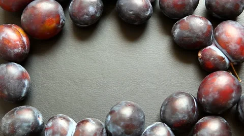 Plum rolls in front of black copy space in the middle of plums Stock Footage 65419416