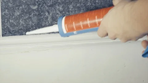 Plumber apply silicone sealant to the joint bathtubs and ceramic tile Stock Footage 104108398