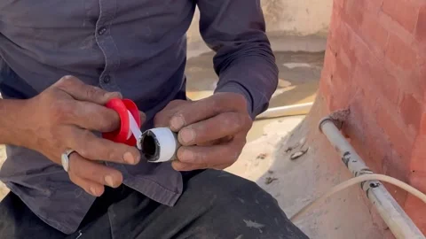 Plumber Applying Teflon Tape to a Pipe Fitting Video stock 345740901