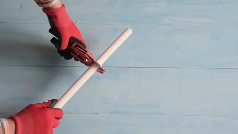 The plumber bites off the polypropylene pipes with pliers. Stock Footage 152455293