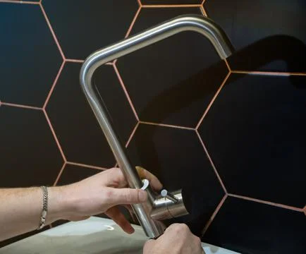 Plumber changes broken, leaking plumbing fixtures in the bathroom. Repair o.. Stock Photos
