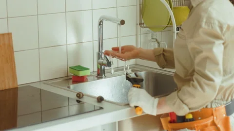 Plumber Checking Kitchen Faucet After Repair Video stock 310150890