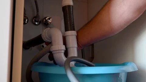 Plumber cleaning clogged sink drain pipe Stock Footage 335512668