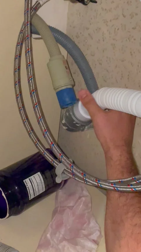 Plumber connecting kitchen drain hose to pipe system. Man repairing sink Stock Footage 340124716