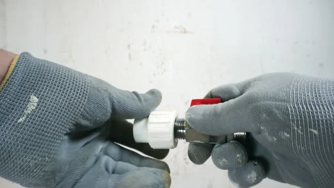 A plumber connects polypropylene pipes. Stock Footage 260926243