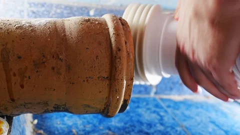 Plumber connects sewage drain pipe in residential bathroom Stock Footage 339005785