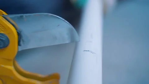Plumber cuts polypropylene pipes using a pipe cutter. Stock Footage 131421891