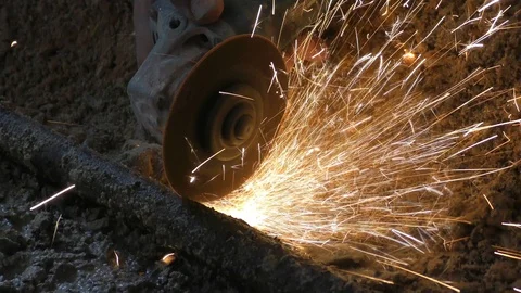 Plumber cuts through metal pipe with radial saw making orange sparks cinemagraph Видео 122646777