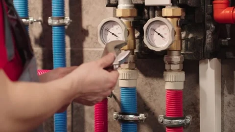 Plumber Detecting Heating System Problem And Taking Wrench Stock Footage 330859067