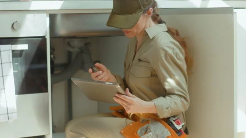 Plumber Diagnosing Kitchen Plumbing Problem Stock Footage 318934359