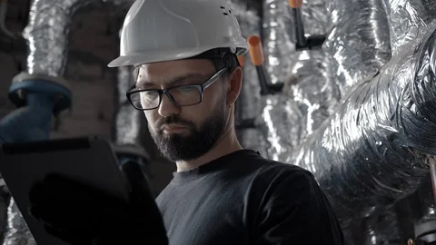 A plumber does a ventilation or heating system check using a gadget. Stock Footage 102374802