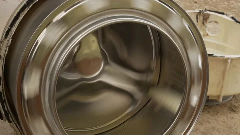 Plumber examines rotation of the washing machine drum. Stock Footage 151459142