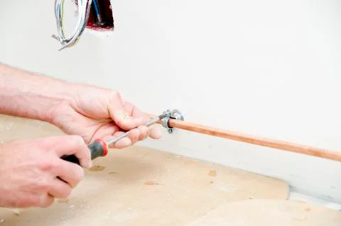 Plumber fixing a copper pipe Stock Photos