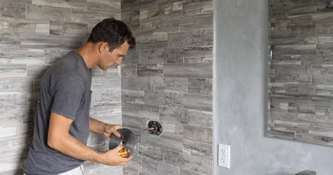 Plumber fixing shower. Workman repairing shower in bathroom. Stock Footage 120670496
