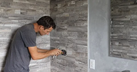 Plumber fixing shower. Workman repairing shower in bathroom. Stock Footage 120670515