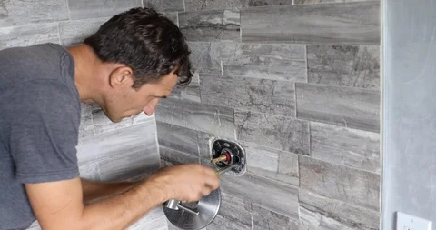 Plumber fixing shower. Workman repairing shower in bathroom. Stock Footage 120670542