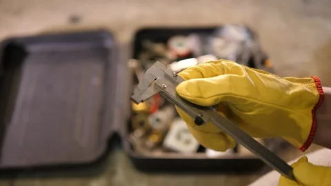 Plumber Handyman checking pipline measuring silver Tool. Toolbox in background.  库存影片 126345458