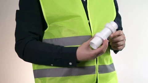 A plumber holds a pipe in his hands and tries to figure out how to install it Stock Footage 312732500