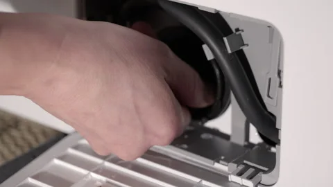 Plumber inserting and tightening washing machine drain pump filter Video stock 345053683