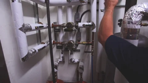 Plumber inspecting pipes for his team 스톡 동영상 70459748